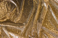 Flot guld-pailletstof med små, tætsiddende, påsyede minipailletter