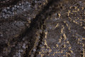 Flot netstof, i mørk brungrå, med påsyede pailletter